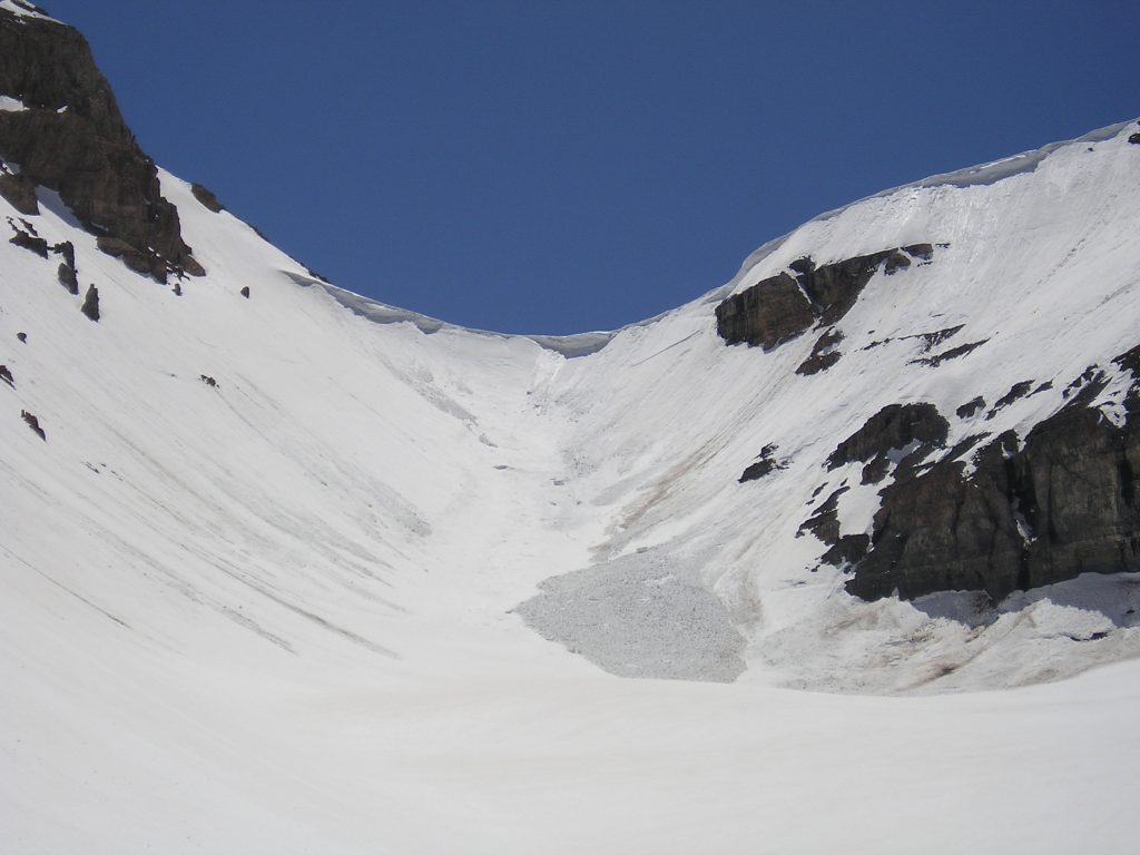 The Timpanogos Glacier is covered with snow and large cornices have formed at the top of it.
